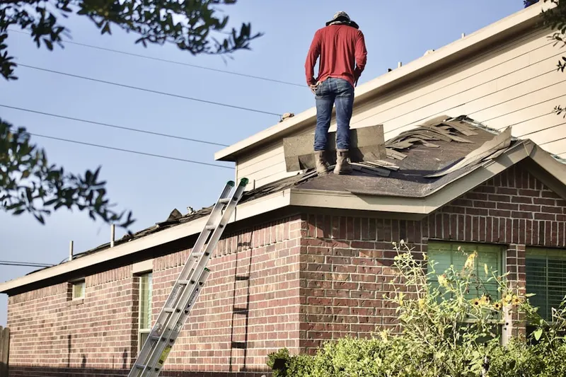Professional roofer working on a residential roof in East Crest Estates